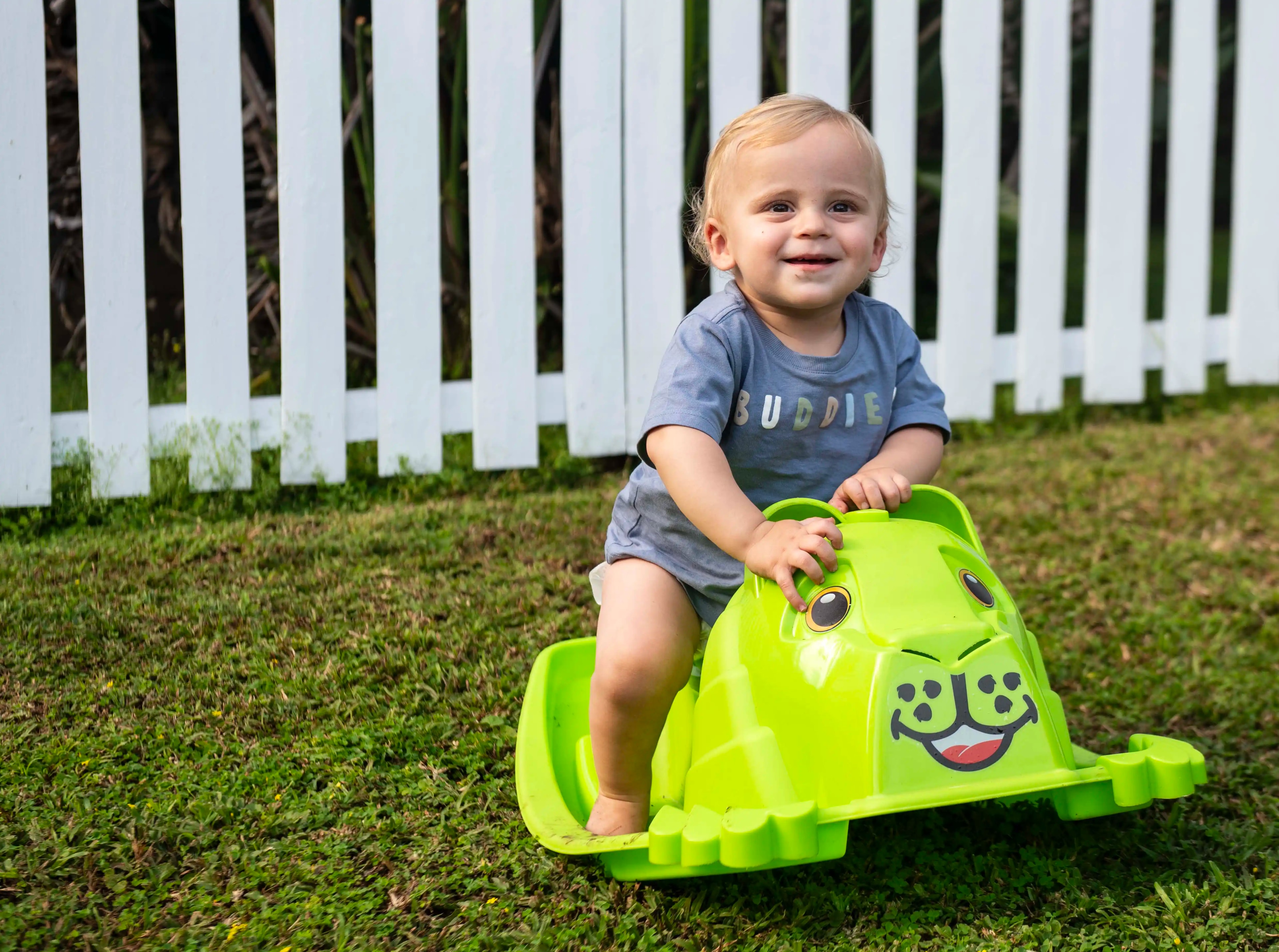 Baby on ride-on toy outside studio
